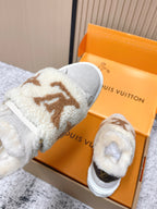 Shearling slip-on sneakers, light gray top view with tan monogram and fur trim