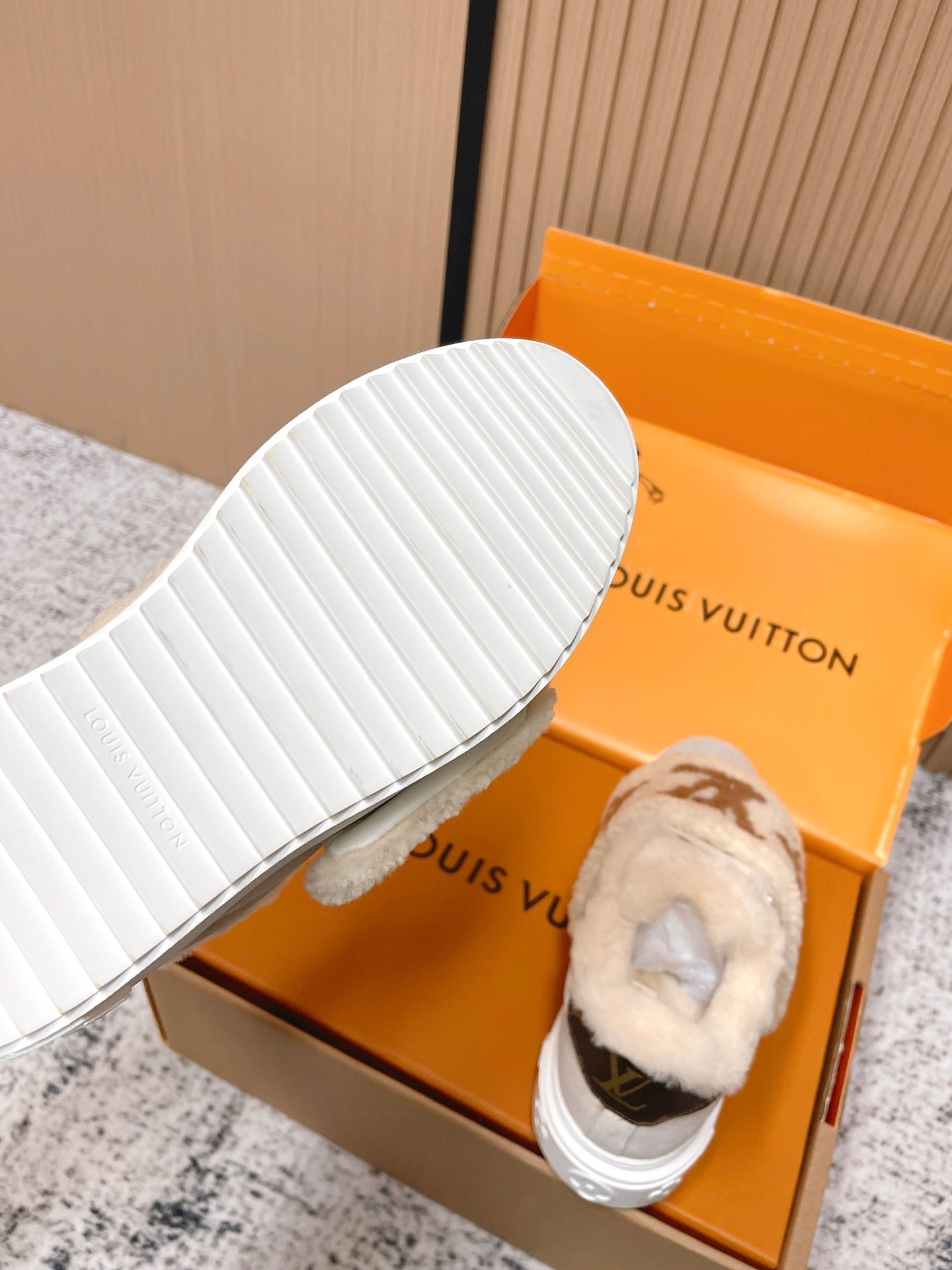 Shearling slip-on sneakers, close view of white ribbed outsole with gray upper