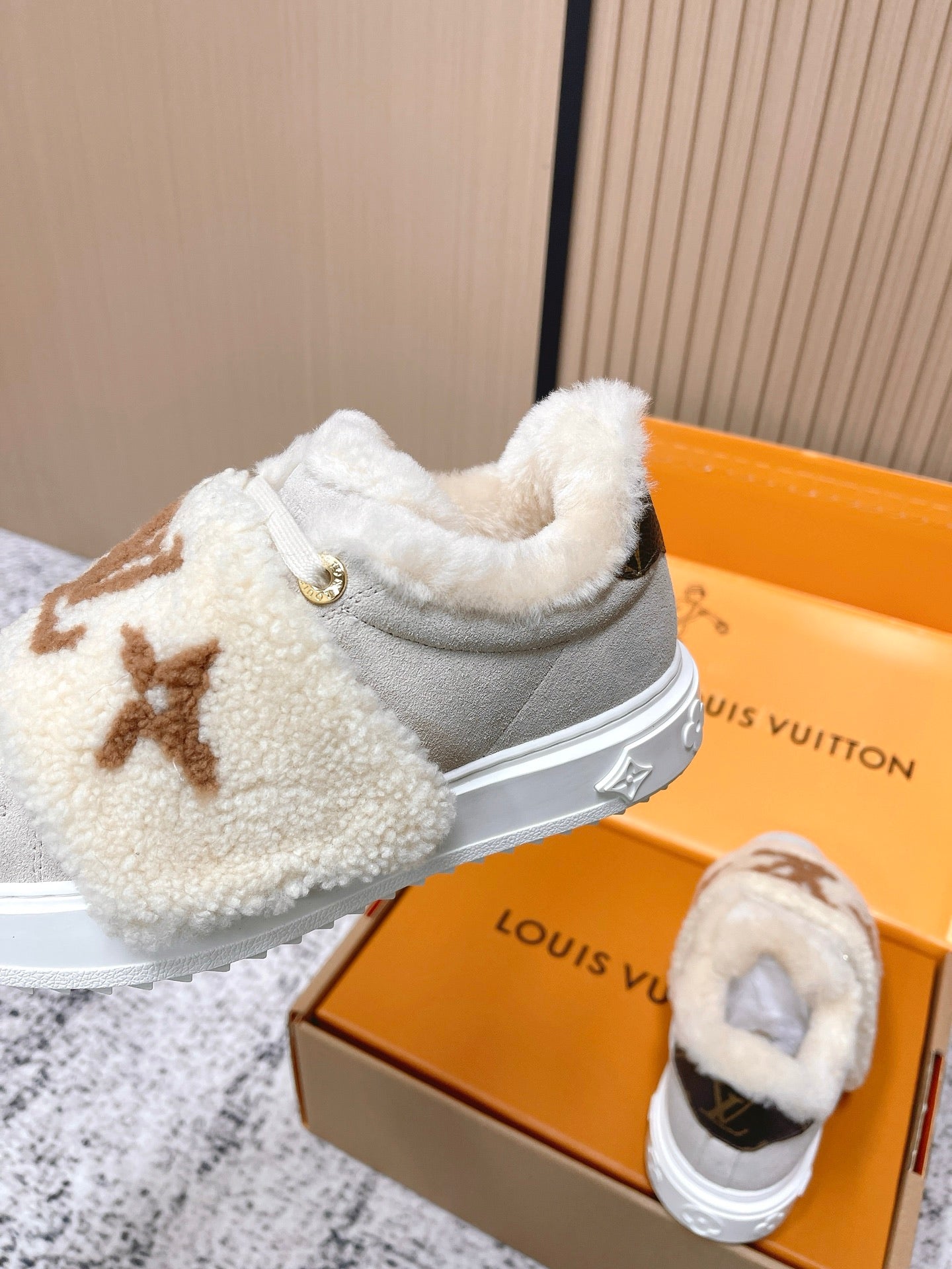 Shearling slip-on sneakers, light gray with tan monogram, side view with gold button