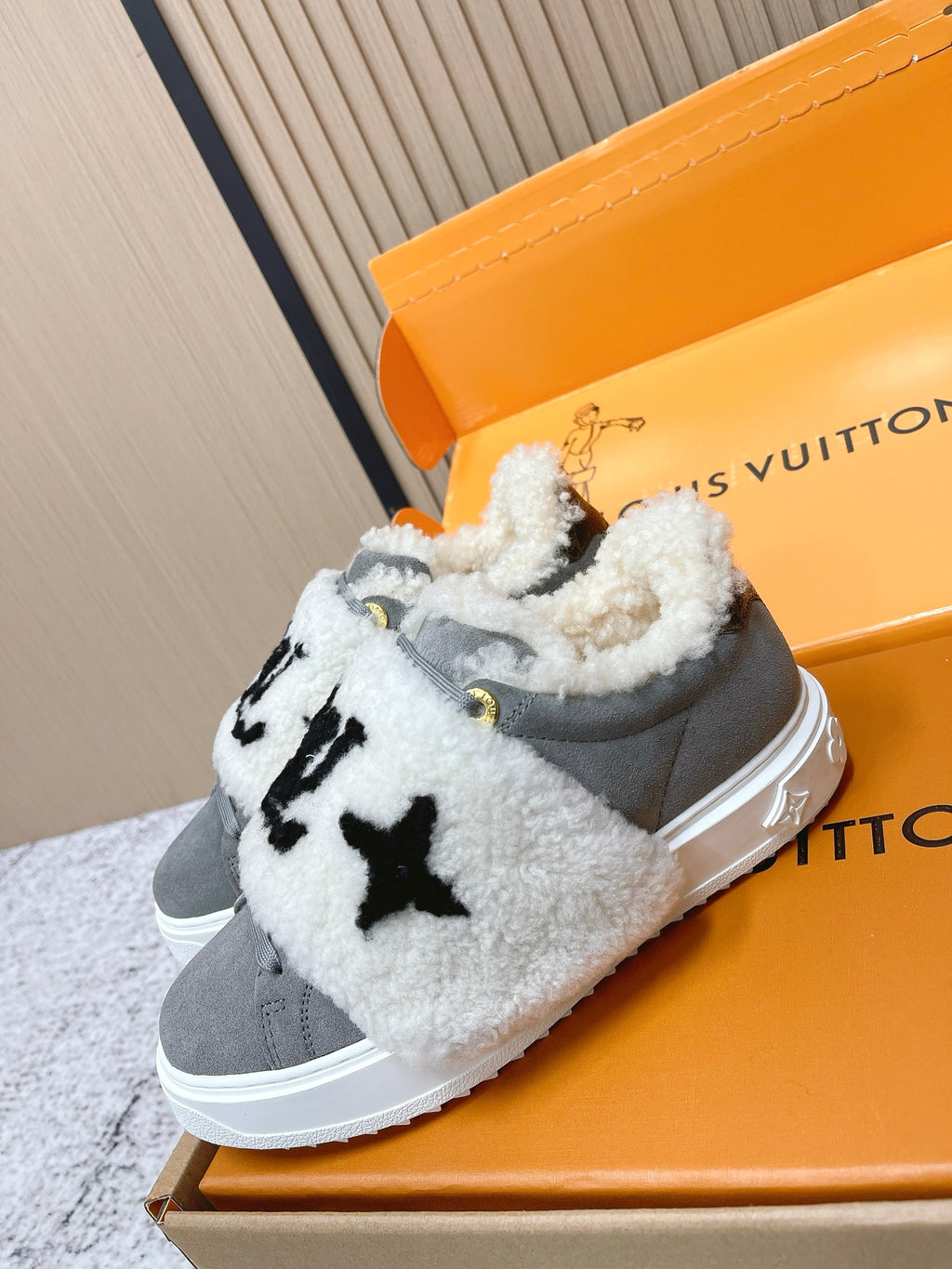 Louis Vuitton unisex sneakers, gray slip-ons with white sherpa hood and black LV-style logo