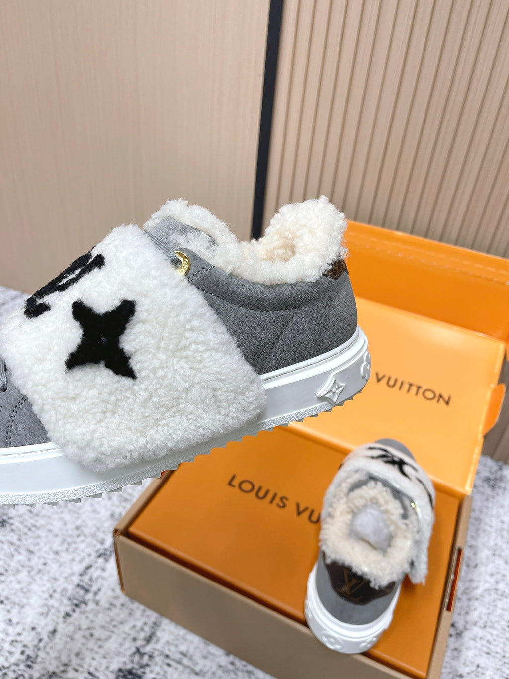 Louis Vuitton unisex sneakers, gray low-tops with white sherpa trim and black logo on strap