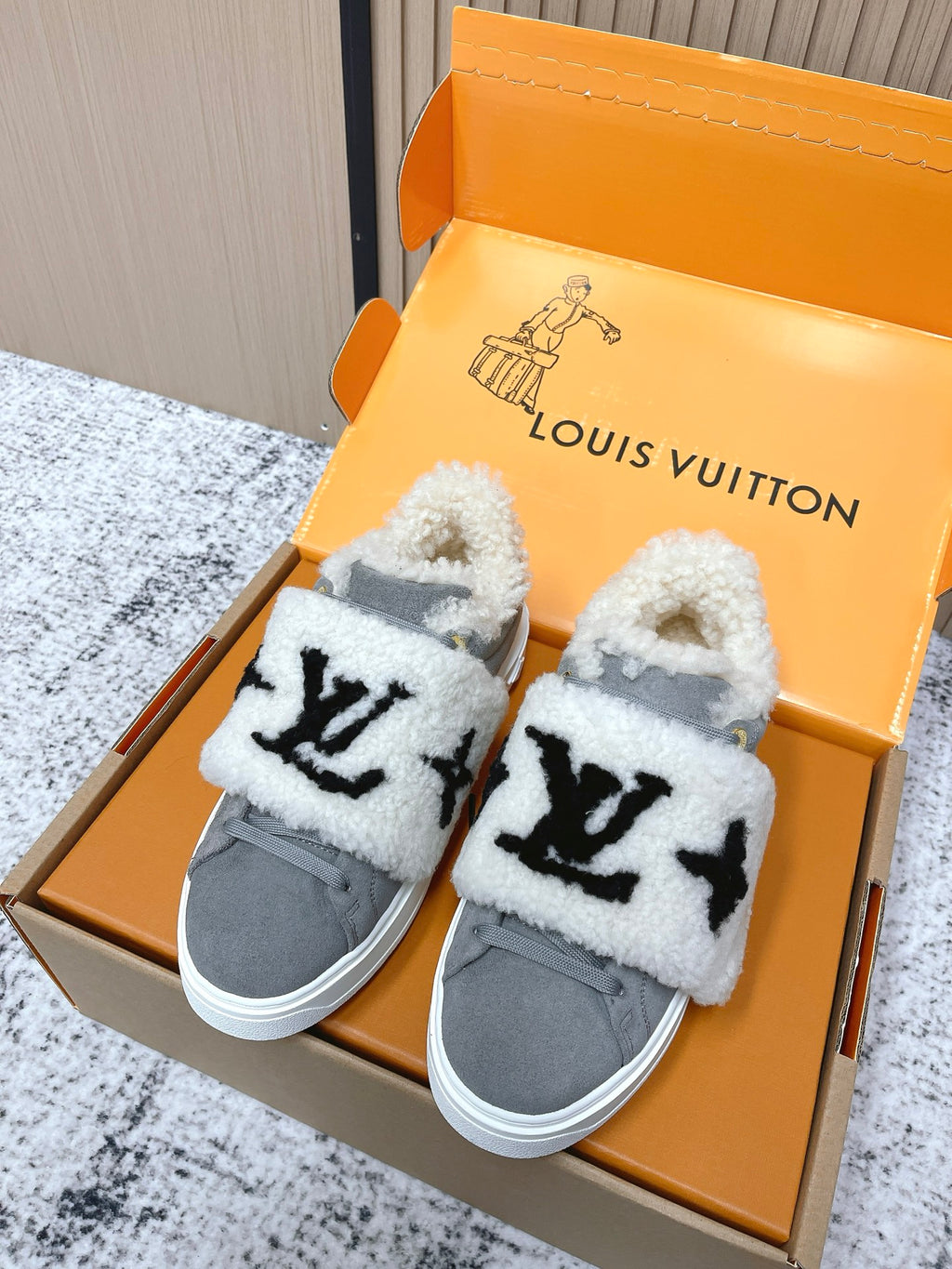 Louis Vuitton unisex sneakers, gray canvas with white sherpa trim and black star-like logo
