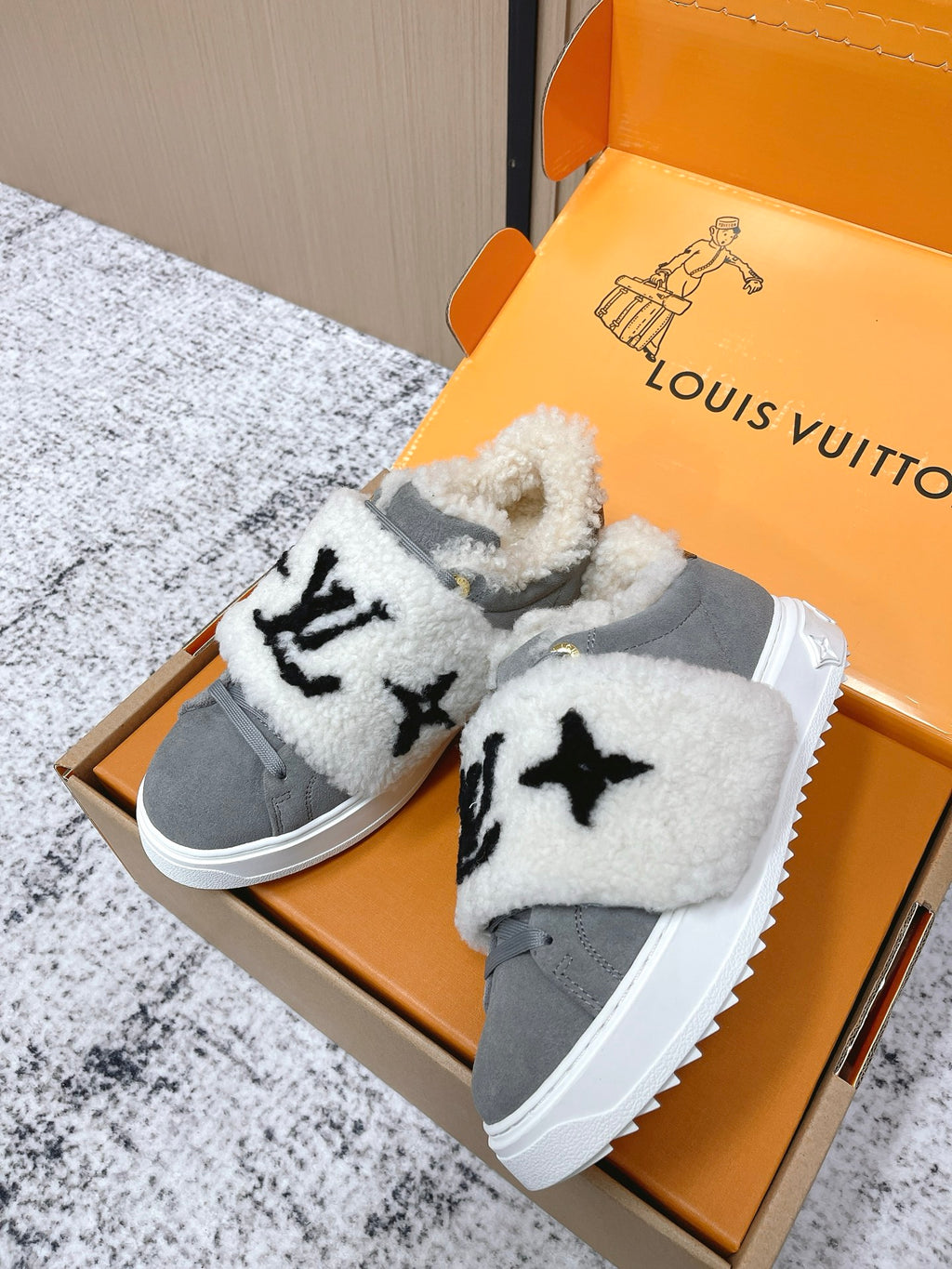 Louis Vuitton unisex sneakers, gray with white fuzzy strap overlays and black emblem print