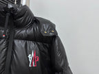 Black puffer jacket shoulder detail with snap button badge and chest logo
