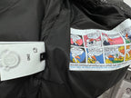 Black puffer jacket lining with colorful graphic print and small white label