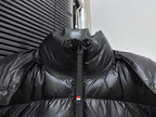 Black long puffer jacket with high collar and center zipper, snap hood detail