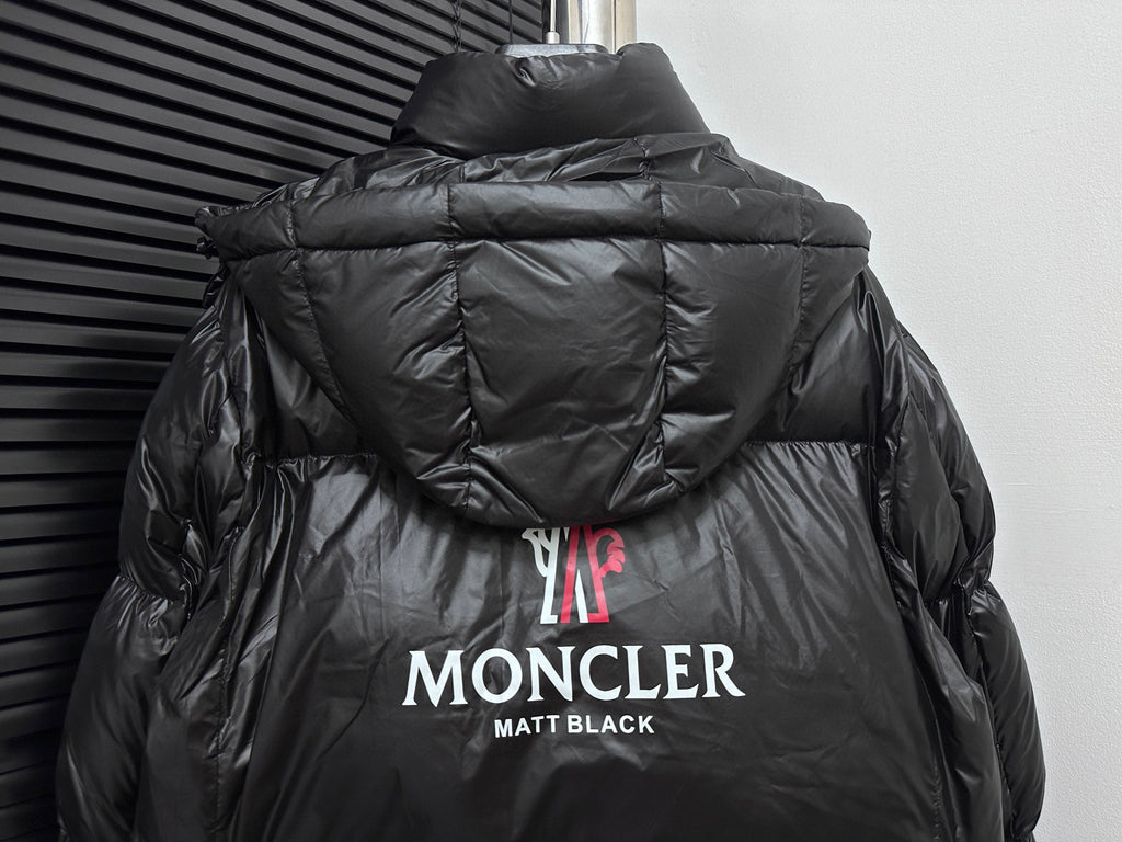 Black long puffer jacket back view with hood and MONCLER logo