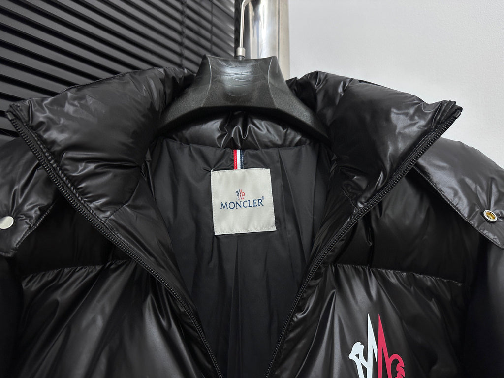 Black puffer jacket interior with white brand label and folded hood lining