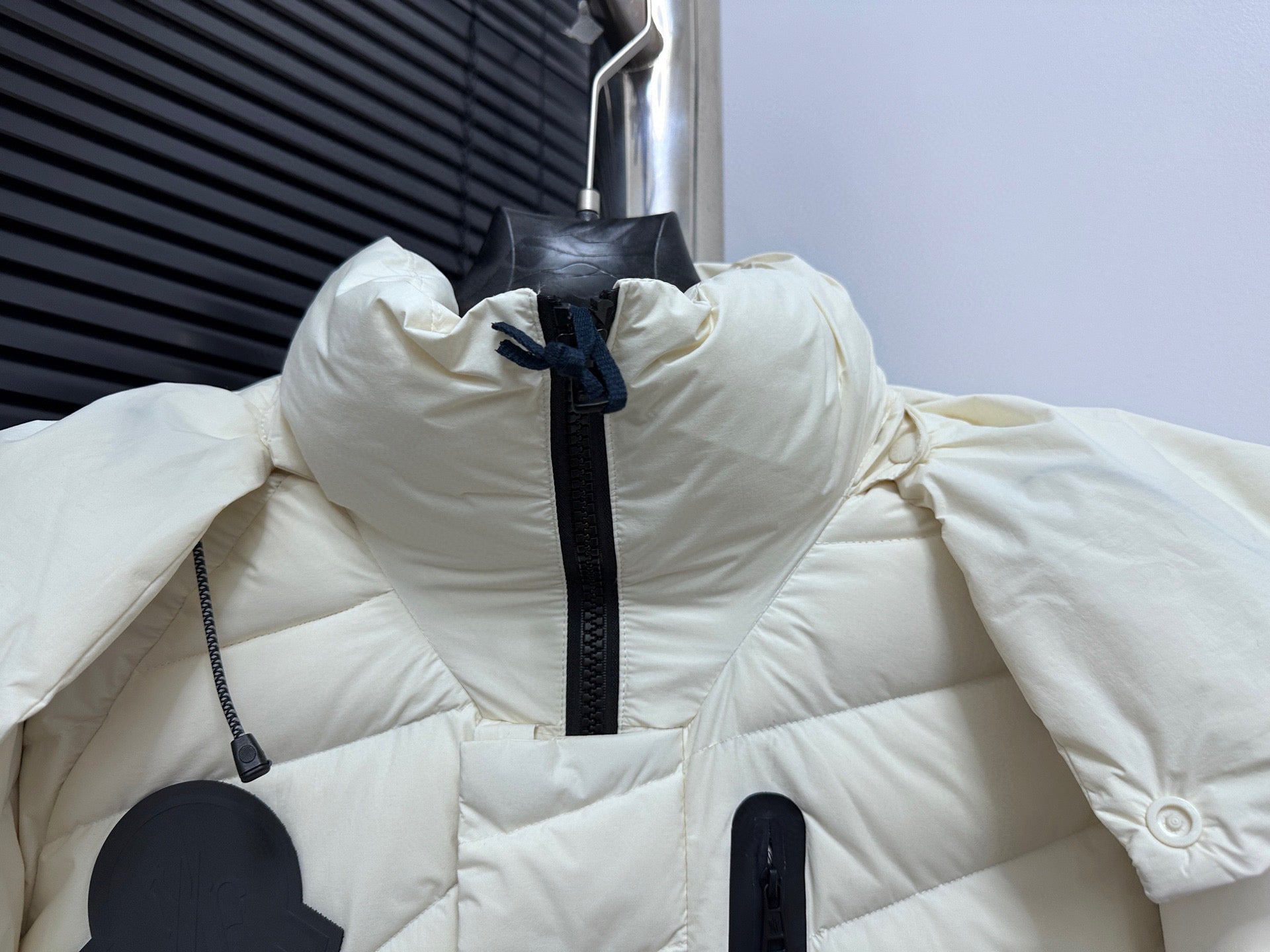 Moncler long white puffer jacket with high collar, hood, and front zipper