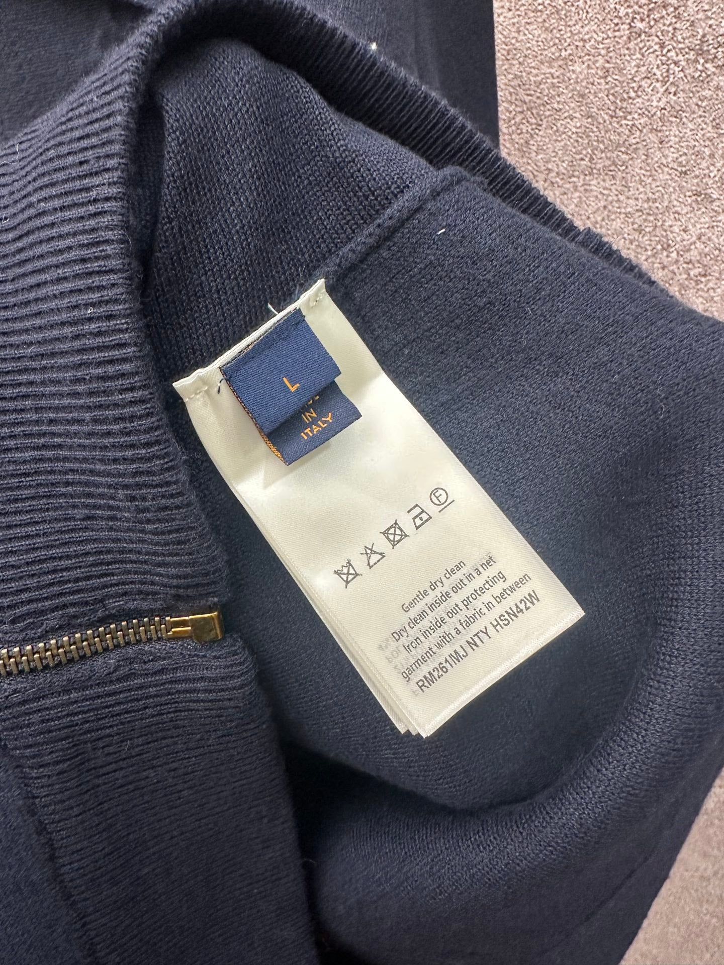 Dark blue long-sleeve zip jacket neckline label (Louis Vuitton) and zipper close-up