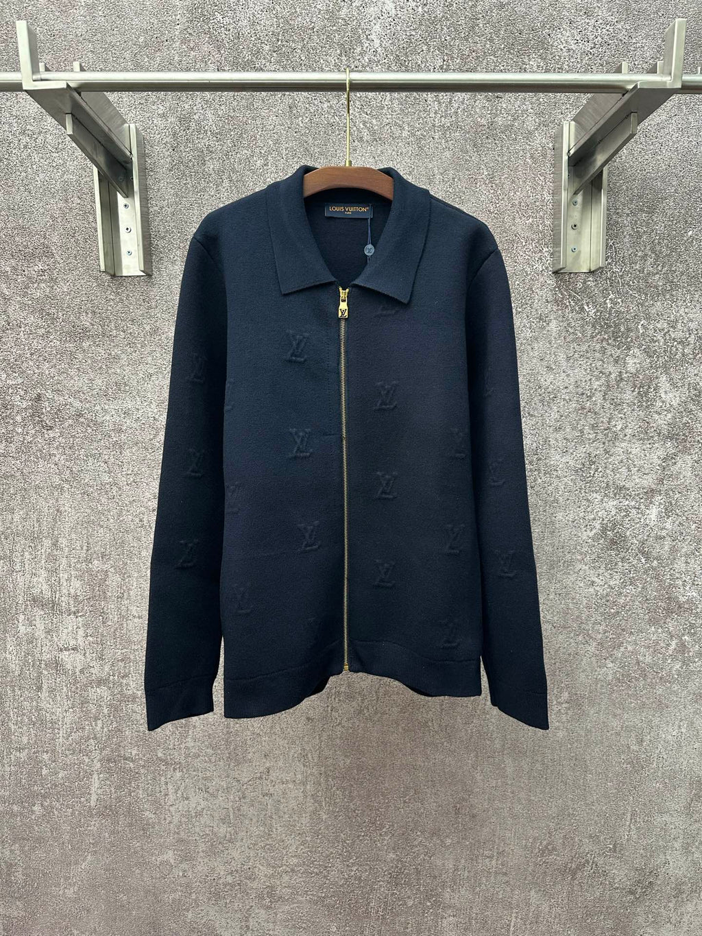 Dark blue long-sleeve zip jacket with pointed collar and gold zipper