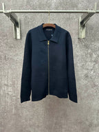 Dark blue long-sleeve zip jacket with pointed collar and gold zipper