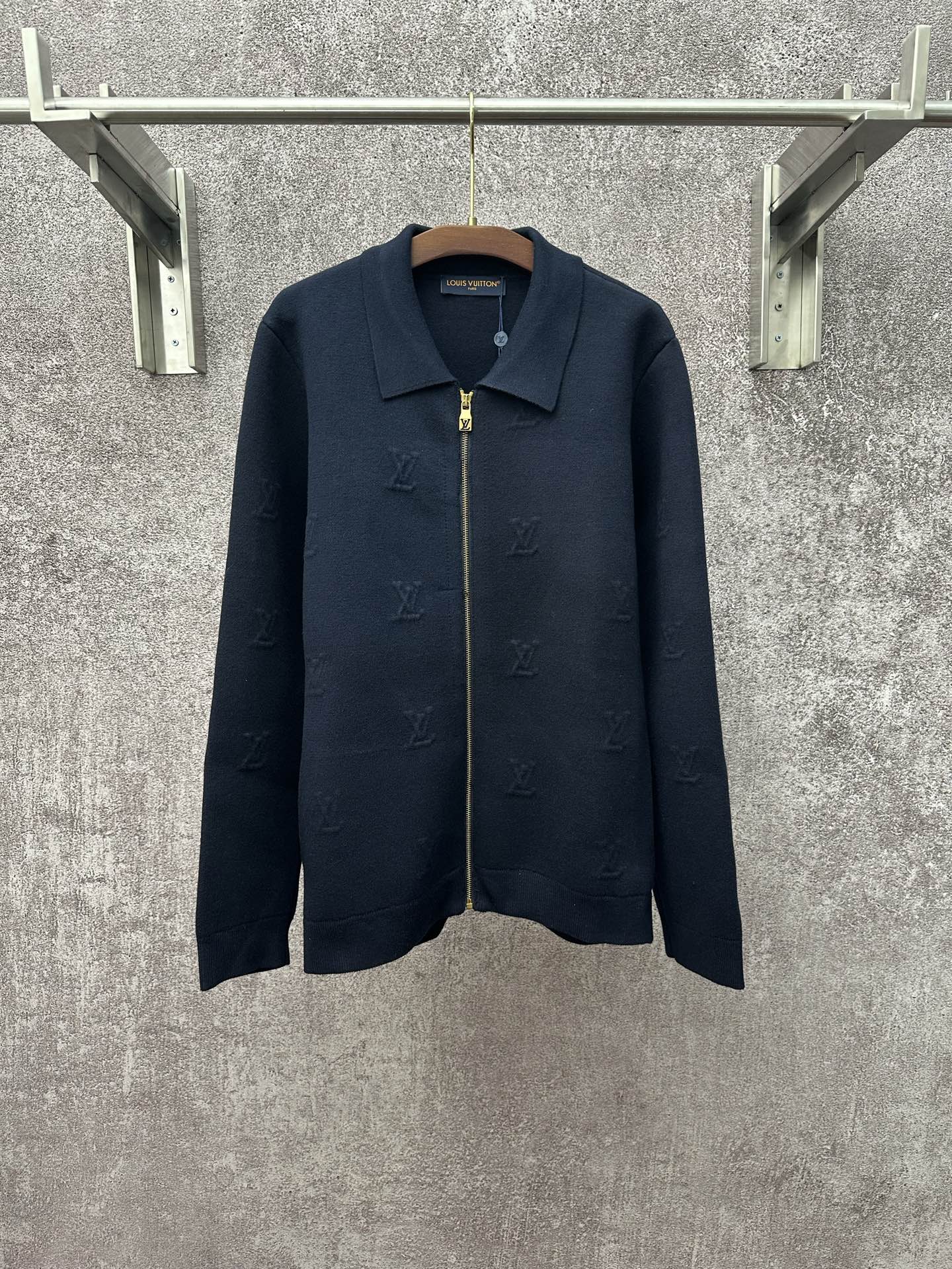 Dark blue long-sleeve zip jacket with pointed collar and gold zipper