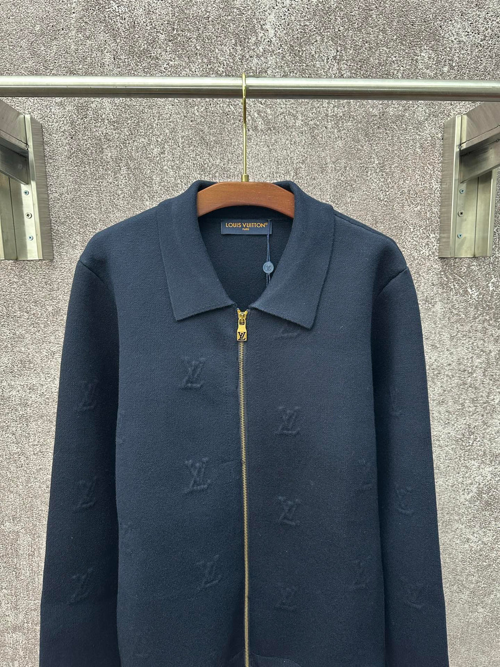 Dark blue long-sleeve zip jacket with pointed collar and gold zipper pull