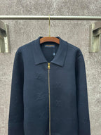 Dark blue long-sleeve zip jacket with pointed collar and gold zipper pull
