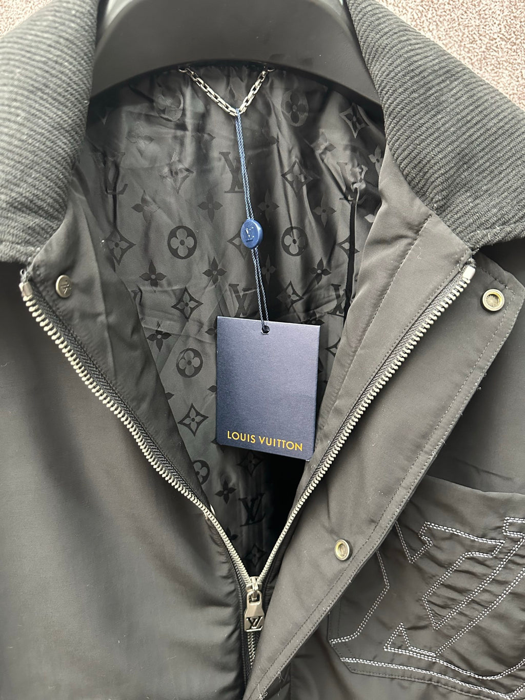 Louis Vuitton long coat, gray monogram-lined hood and front zipper