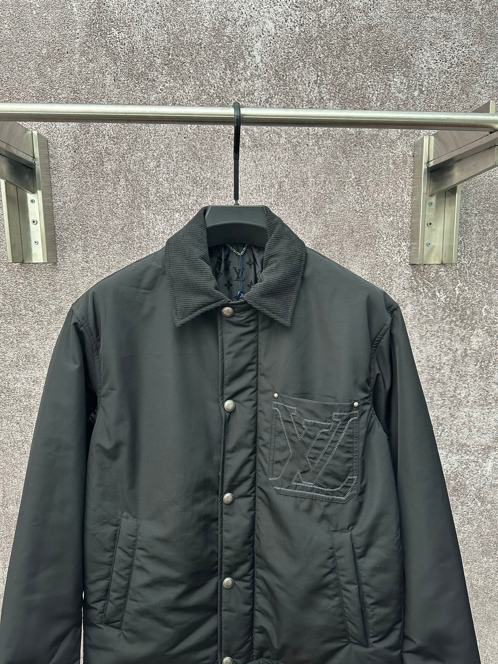 Long puffer jacket, dark green, front view with button closure and logo chest pocket