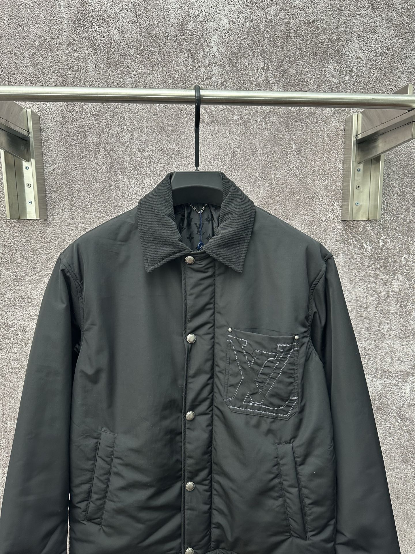 Long puffer jacket, dark green, front view with button closure and logo chest pocket