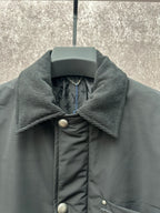 Long puffer jacket neckline, dark green ribbed collar and metal button trim