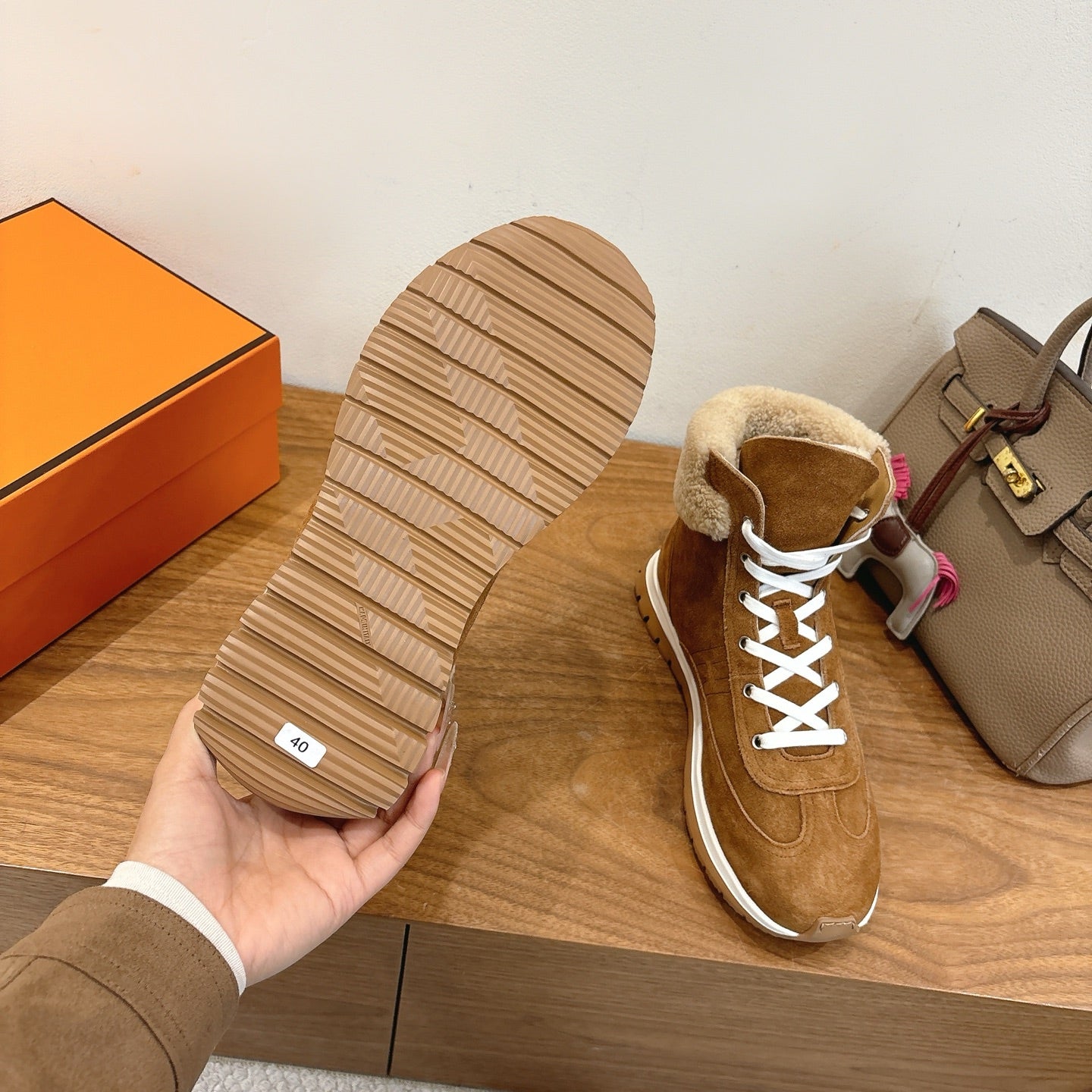 Hermes unisex sneaker outsole with tread and brown suede upper, white laces