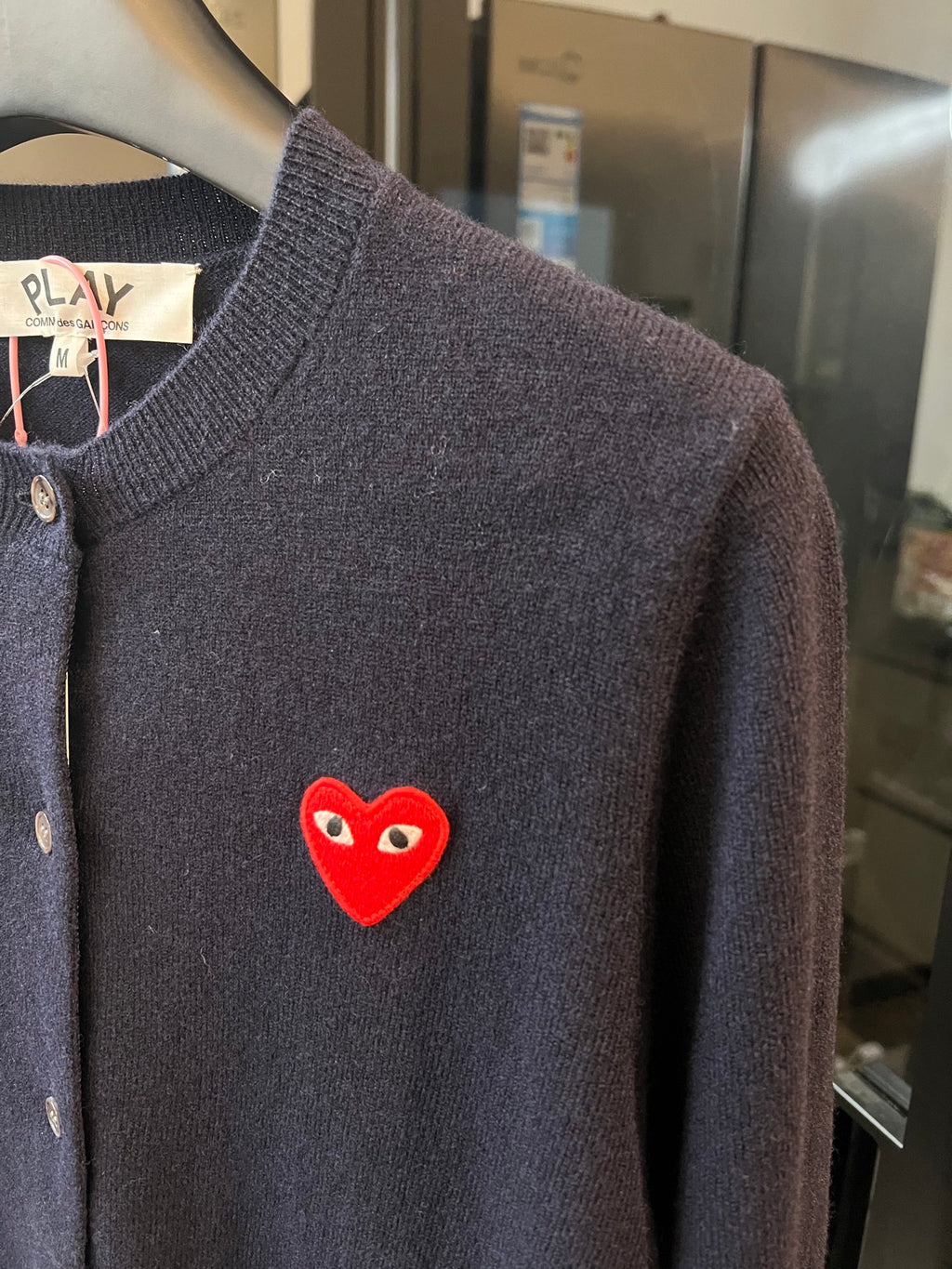 Dark navy knit cardigan sleeve and chest with red heart patch detail