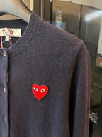 Dark navy knit cardigan sleeve and chest with red heart patch detail