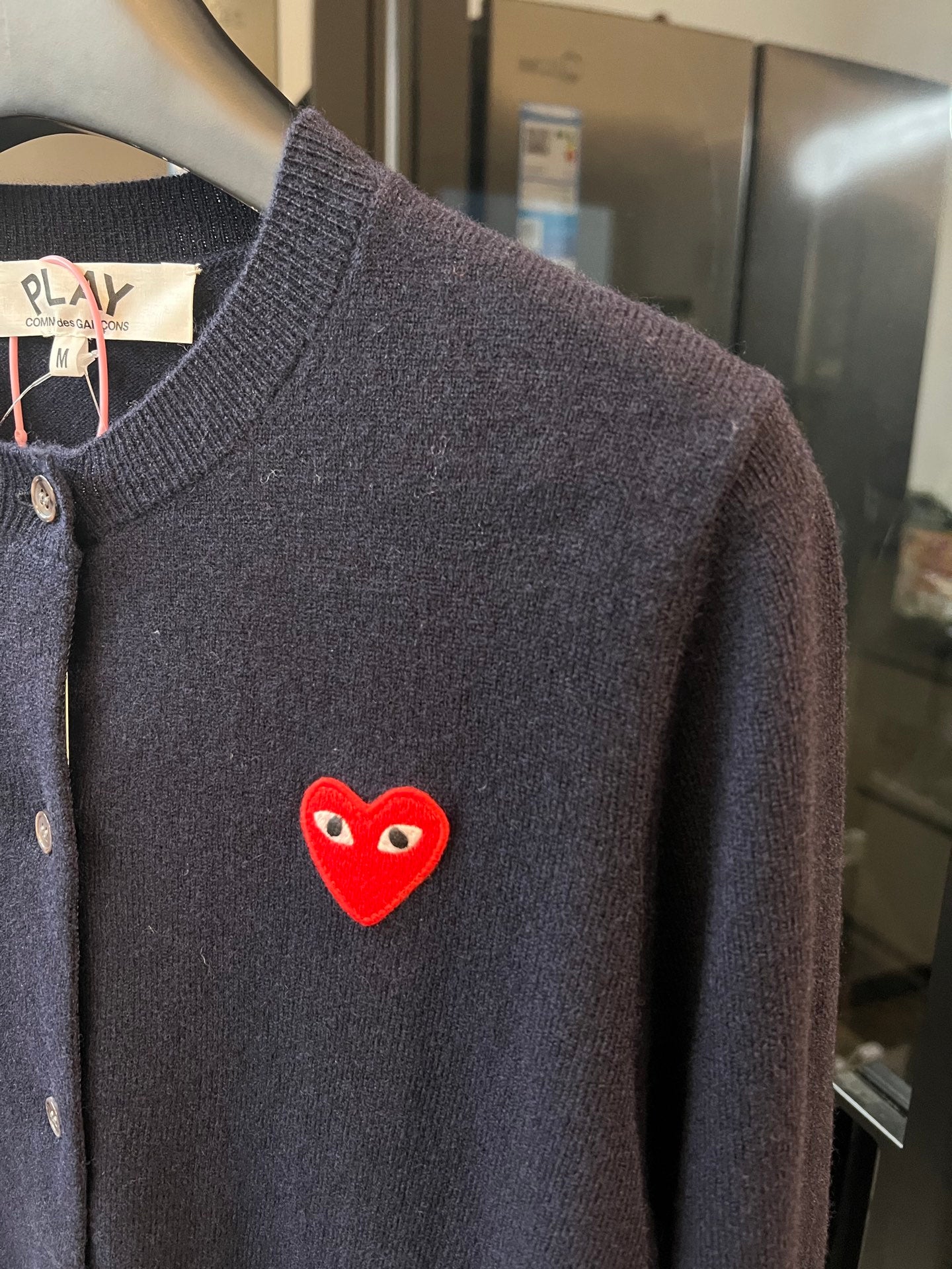Dark navy knit cardigan sleeve and chest with red heart patch detail