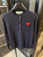 Dark navy knit cardigan with button front and red heart patch on the left chest