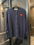 Dark navy knit cardigan with button front and small red heart patch on the left chest