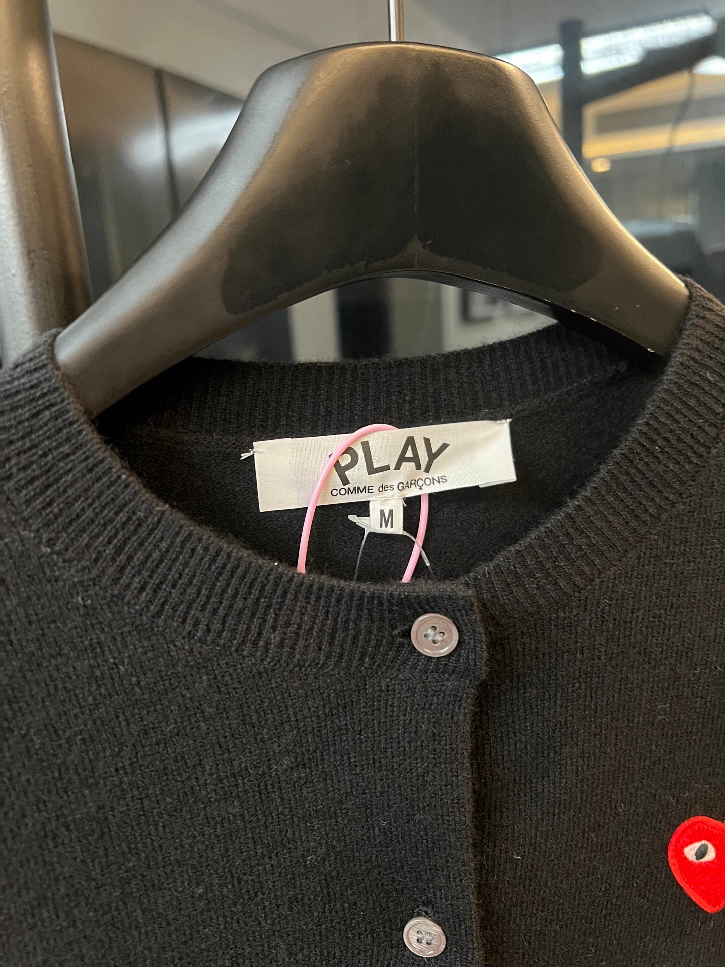 Amiri PLAY cardigan neckline with button placket and red heart logo.