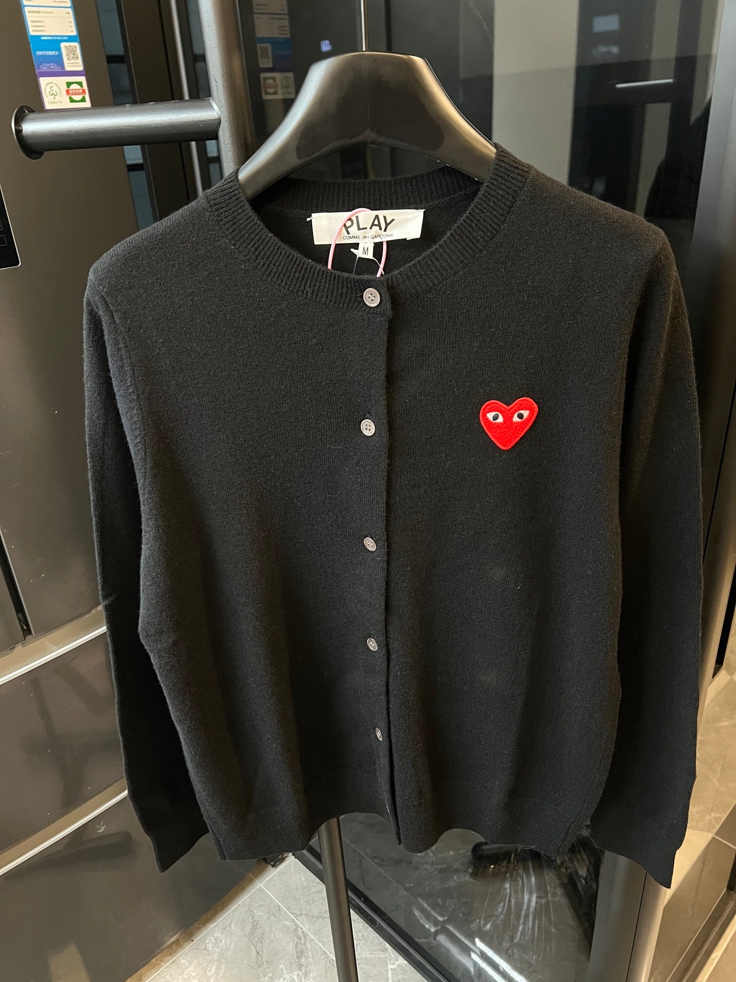 Amiri cardigan in dark knit with button front and red heart logo patch.
