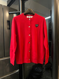 Red knit cardigan sweater with button front and black cat-face heart applique