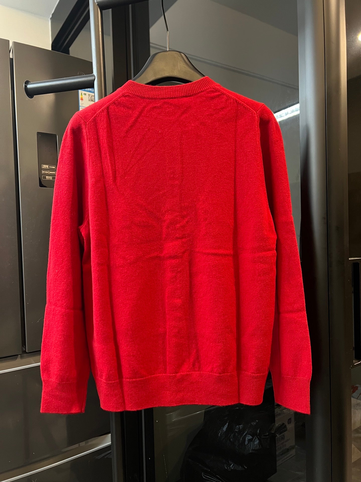 Red knit cardigan sweater back view with ribbed crew neck and long sleeves