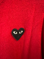 Black cat-face heart applique on red knit cardigan fabric