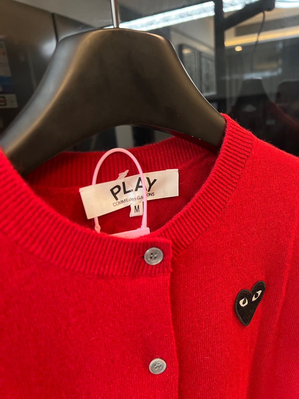 Red knit cardigan neckline with button placket and black cat-face heart applique