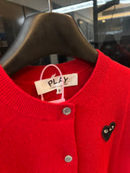 Red knit cardigan neckline with button placket and black cat-face heart applique