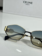 Gold-trim sunglasses with blue lenses and black temples, close-up side view