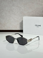 Black-and-gold sunglasses with dark lenses and gold bridge detail, front view