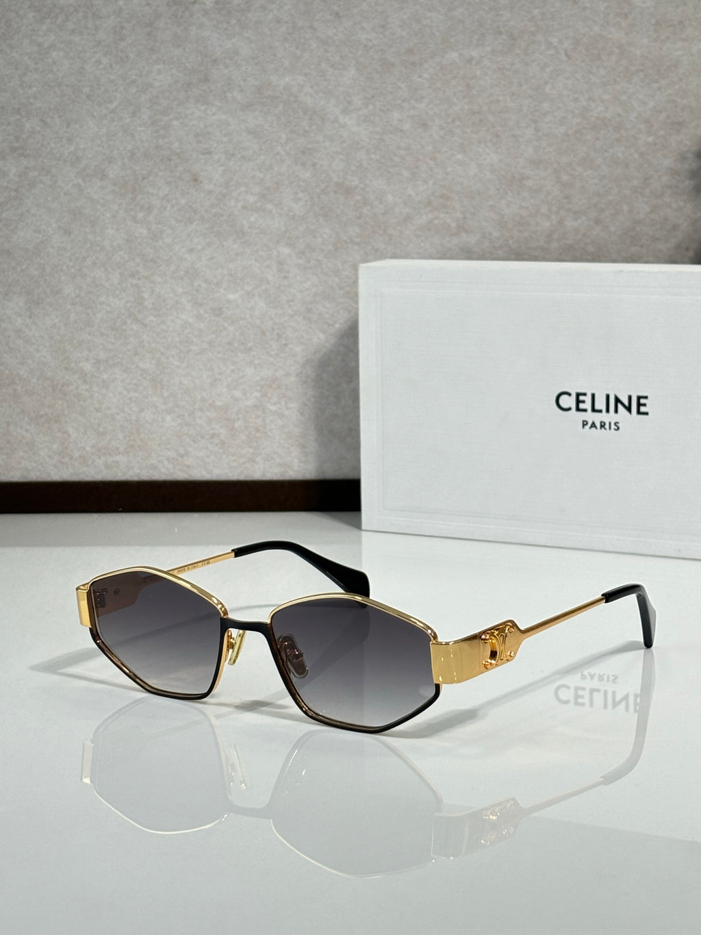 Gold-and-black sunglasses with dark lenses, front view