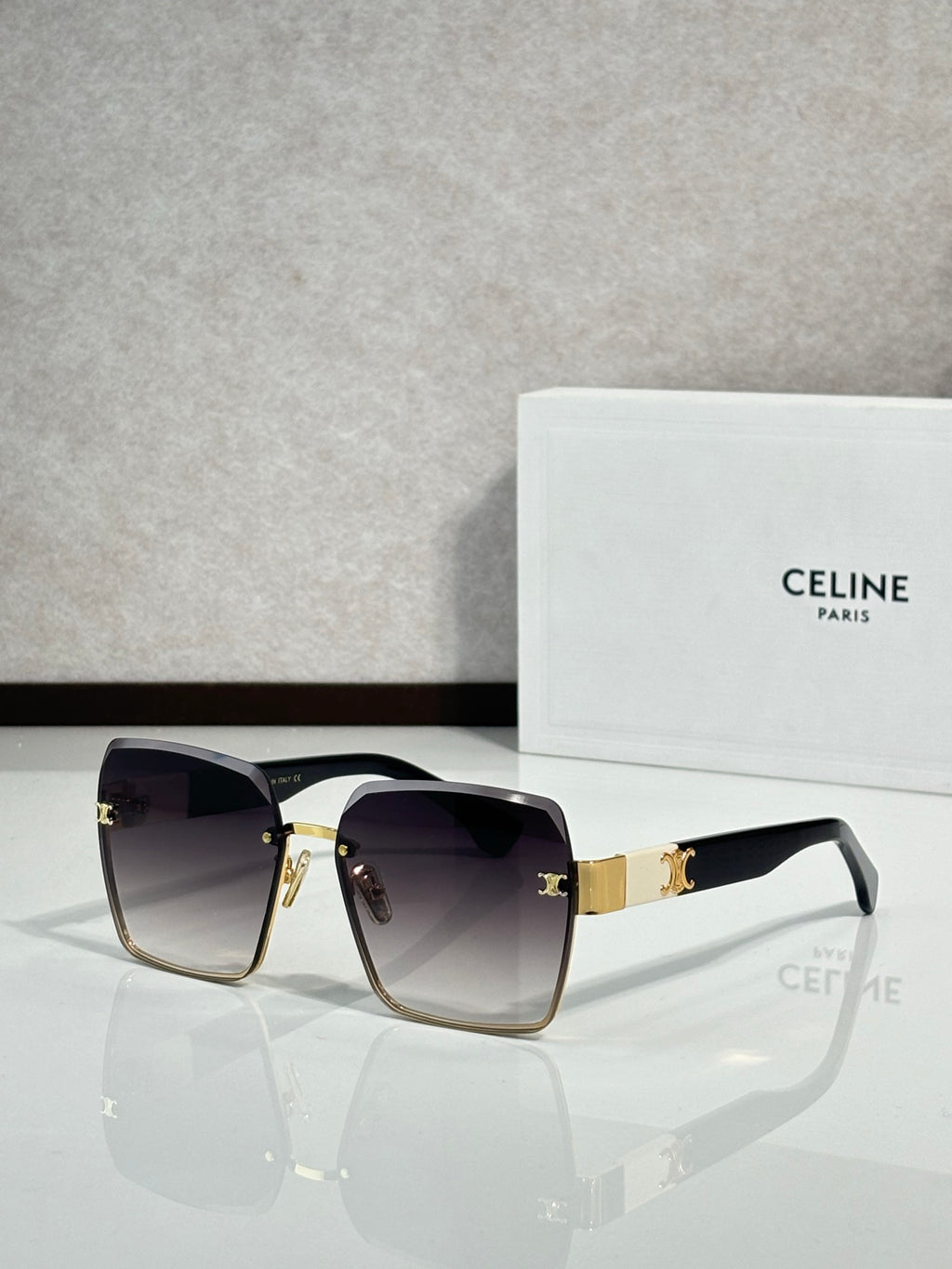 Celine sunglasses with gold-tone frame and dark lenses, rectangular square cat-eye