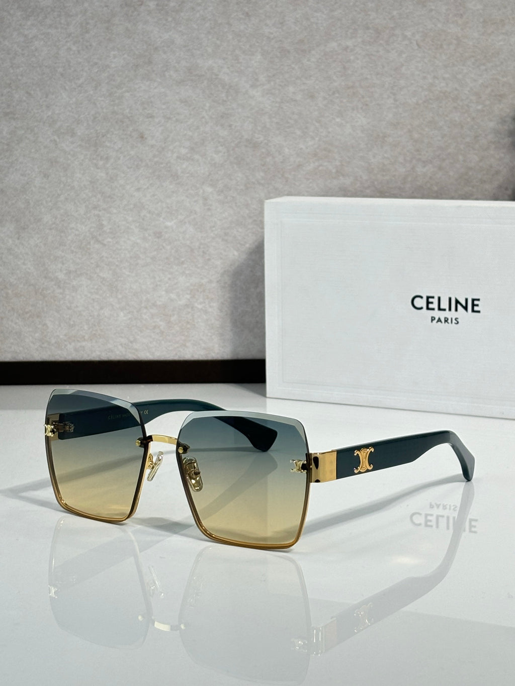 Celine sunglasses with gold-tone frame and amber gradient lenses, square cat-eye