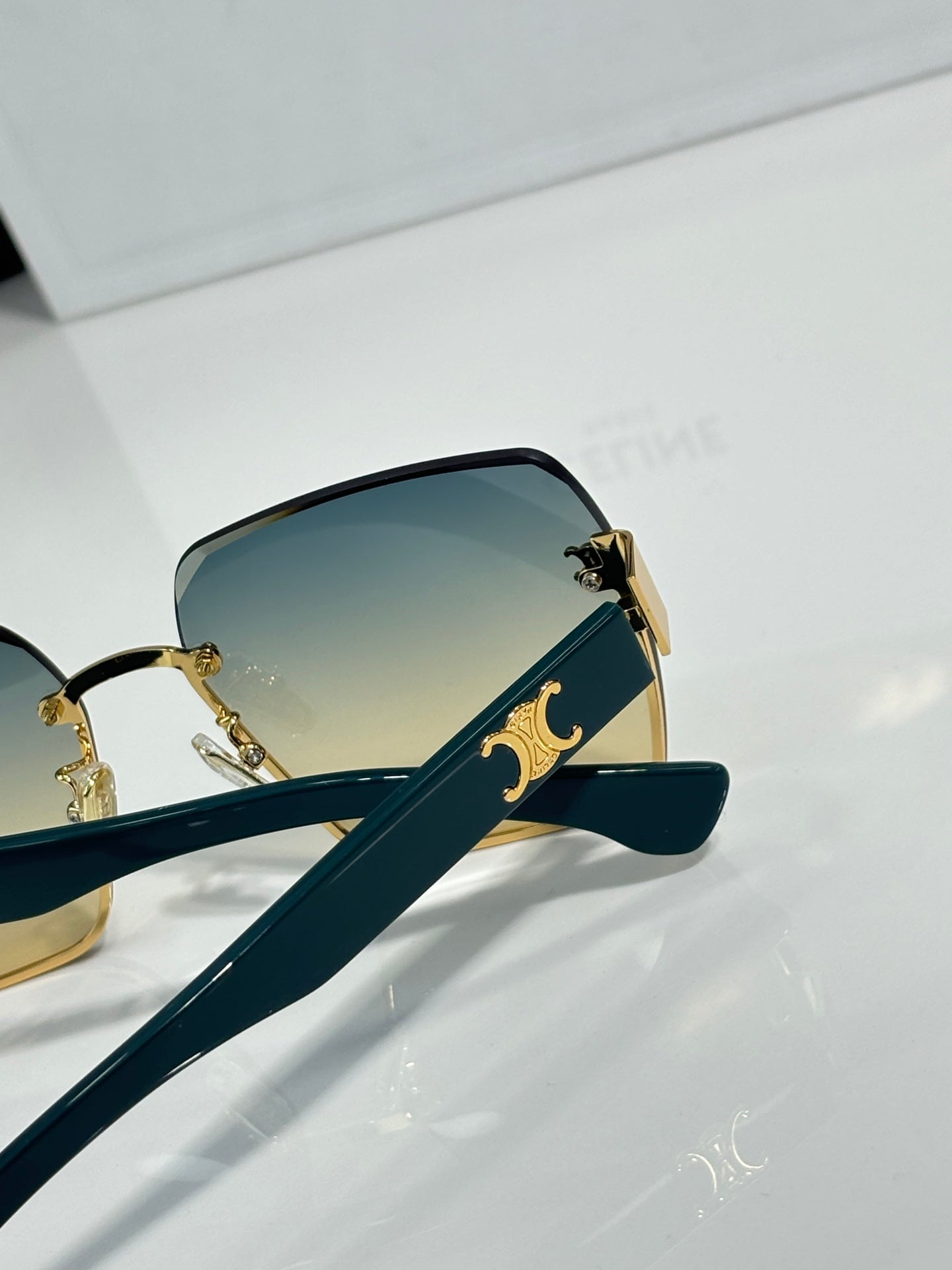 Celine sunglasses side view with gold-tone arms and gradient lenses, square cat-eye