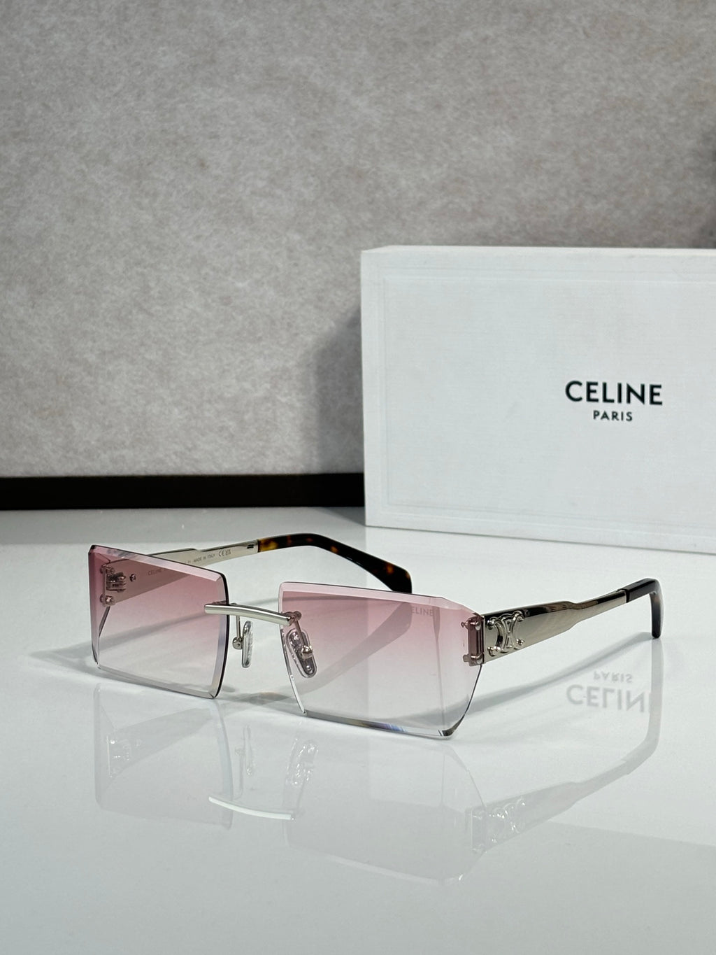Celine sunglasses with pink-tinted rectangular lenses, dark frame, and silver hardware
