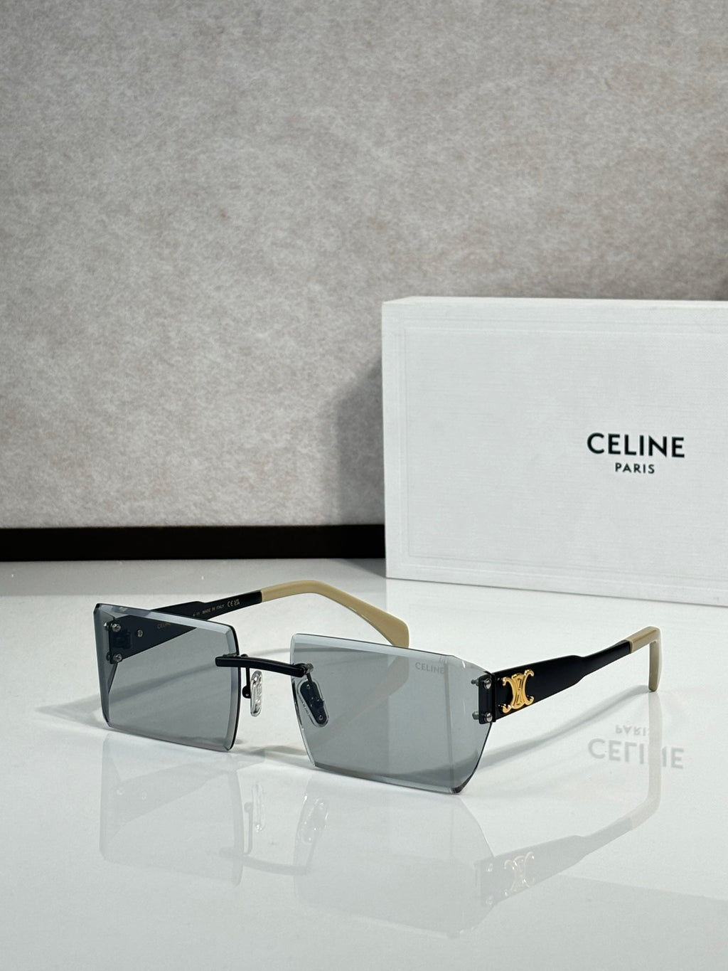 Celine sunglasses with dark rectangular lenses, black frame, and gold-tone temple tips