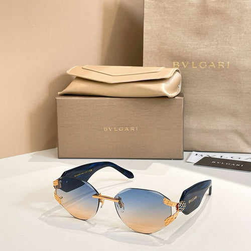 Blue-tinted gradient sunglasses with gold-tone frame and patterned temple accents