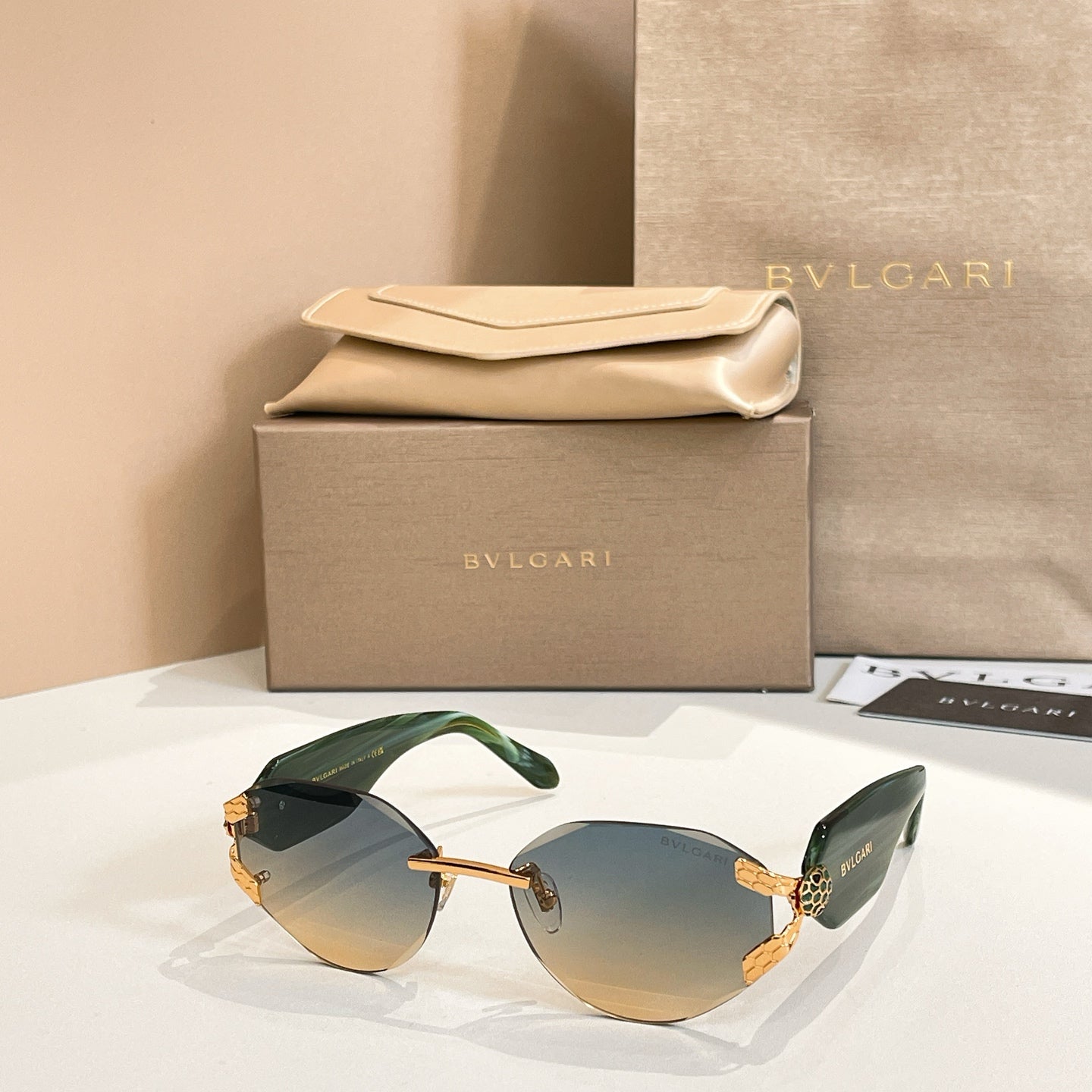 Green-tinted gradient sunglasses with gold-tone frame and decorative temple details