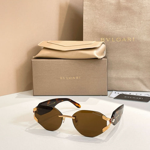 Brown-tinted gradient sunglasses with gold-tone frame and tortoiseshell-style temple arms