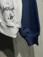Hoodie sleeve cuff and chest graphic on light gray fabric