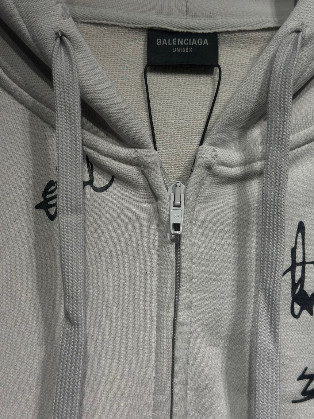 White zip-up hoodie with hood, drawcords, and center front zipper