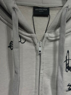 White zip-up hoodie with hood, drawcords, and center front zipper